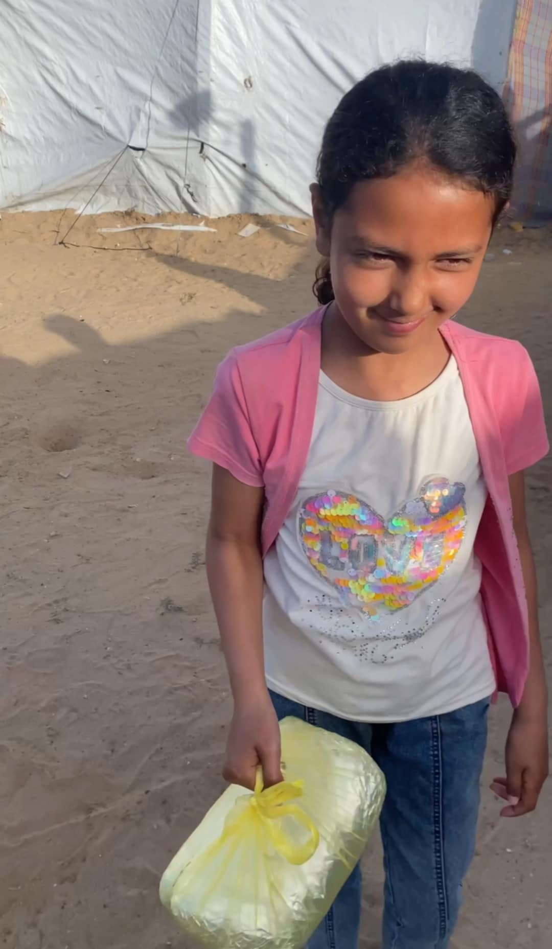 Young girl receiving medical aid and supplies from volunteer healthcare workers in Gaza