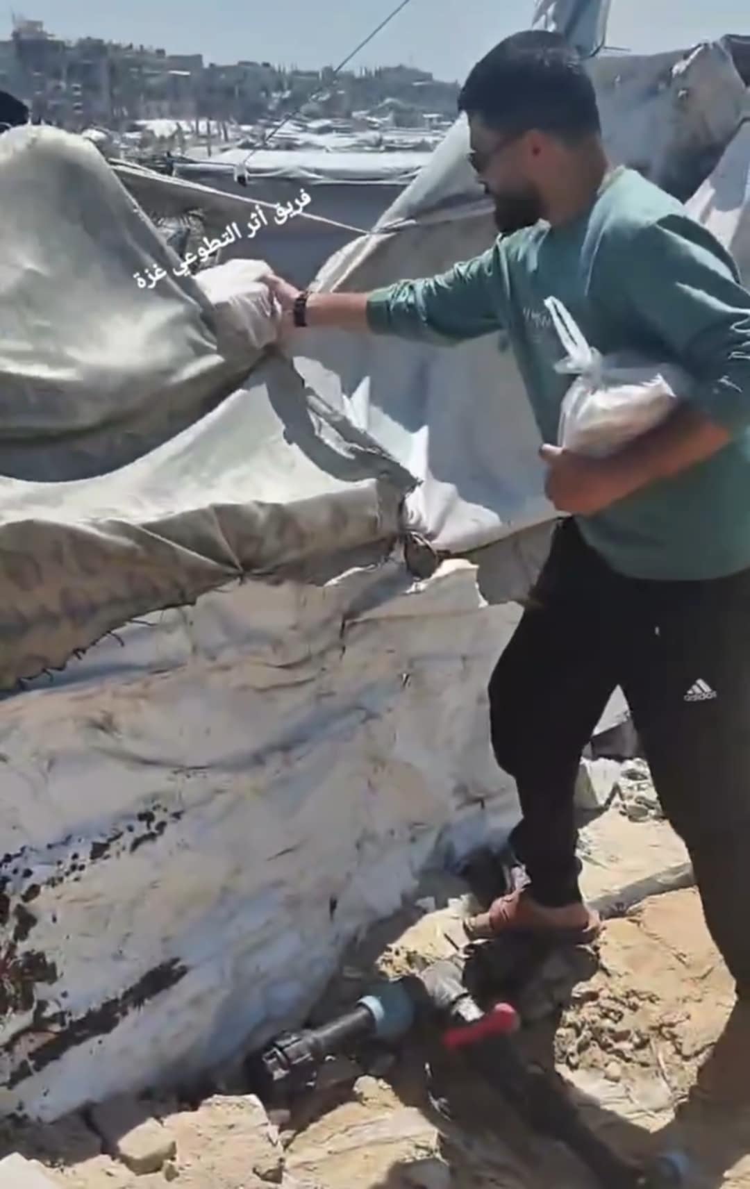 Volunteers setting up emergency shelter tents for displaced families in Gaza, providing crucial protection from the elements