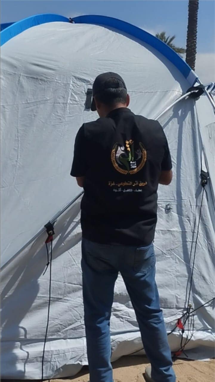 Volunteer team setting up a medical tent for emergency healthcare services